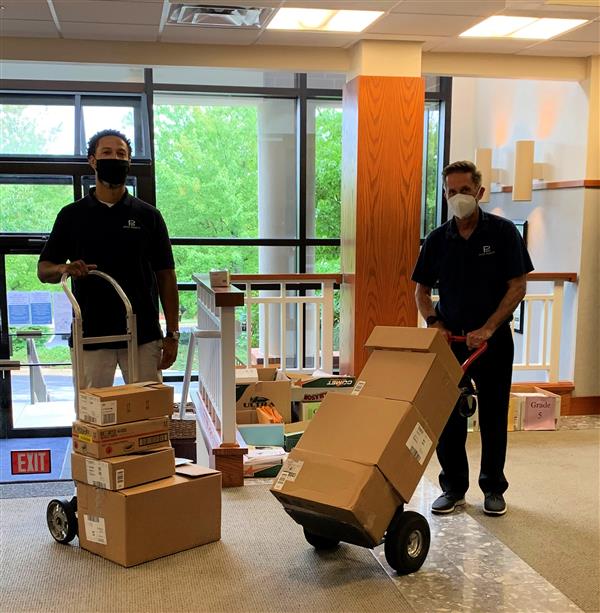 Anton Burrell and Mac Neilon deliver donated school supplies. 